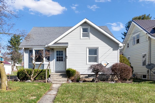 71 Raymond Ave, Shelby, OH 44875 - bungalow-style house with a shingled roof and a front lawn
