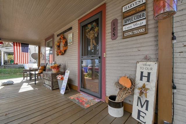 wooden terrace featuring covered porch