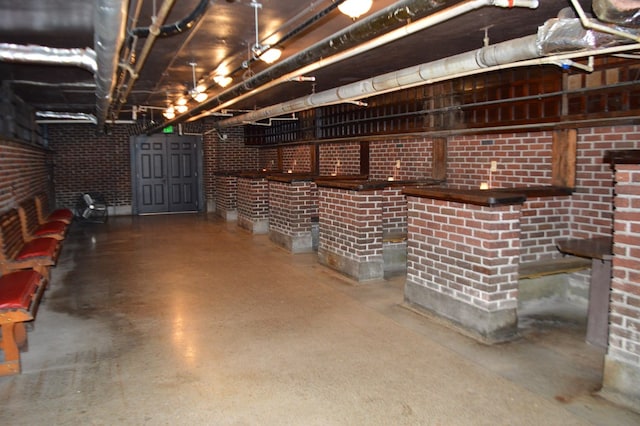 basement with brick wall