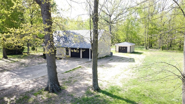 5616 Windfall Rd, Galion, OH 44833 - detached garage featuring a view of trees