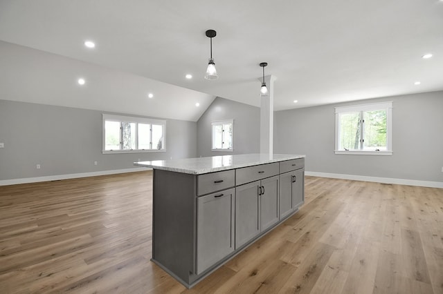 5616 Windfall Rd, Galion, OH 44833 - kitchen with open floor plan, gray cabinets, healthy amount of natural light, a center island, and lofted ceiling