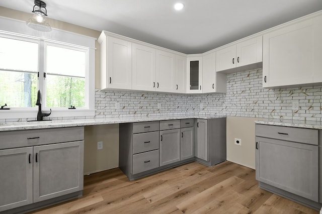 5616 Windfall Rd, Galion, OH 44833 - kitchen with gray cabinets, a sink, backsplash, light stone counters, and recessed lighting