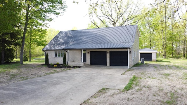 5616 Windfall Rd, Galion, OH 44833 - view of front of home featuring brick siding, metal roof, and a garage