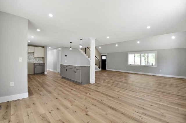 5616 Windfall Rd, Galion, OH 44833 - unfurnished living room with stairs, light wood-style floors, recessed lighting, and baseboards