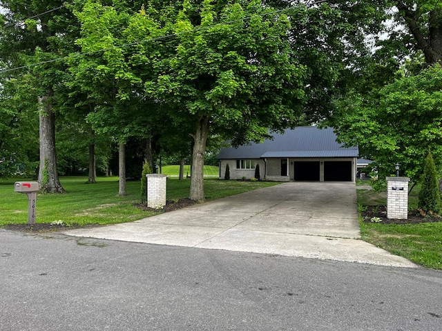 5616 Windfall Rd, Galion, OH 44833 - view of front of house featuring a garage, a front yard, driveway, and metal roof