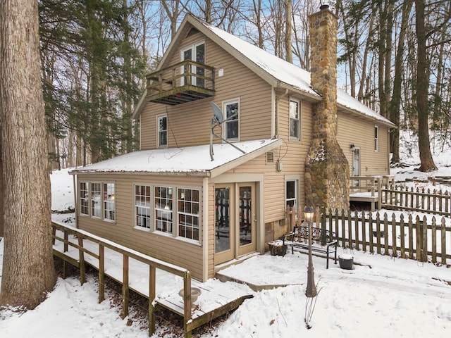 snow covered house with a balcony