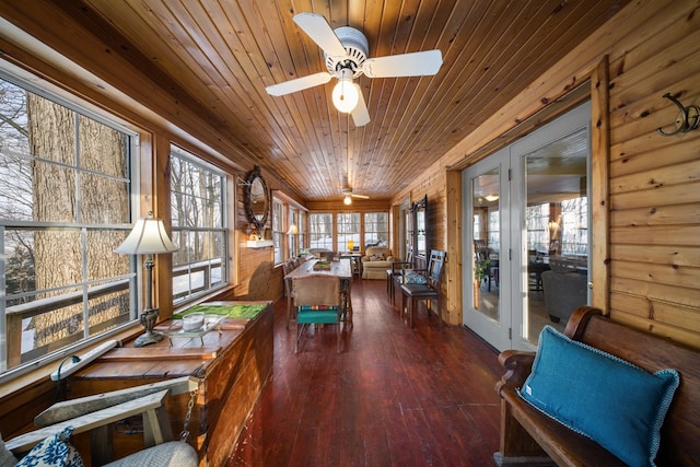 sunroom featuring ceiling fan, a wealth of natural light, and wood ceiling