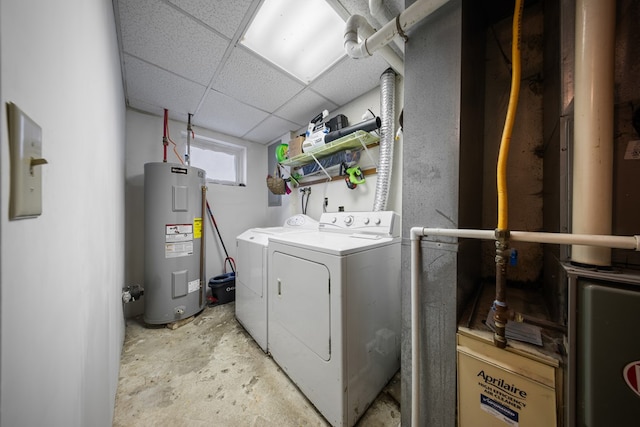 washroom with electric water heater and washing machine and clothes dryer