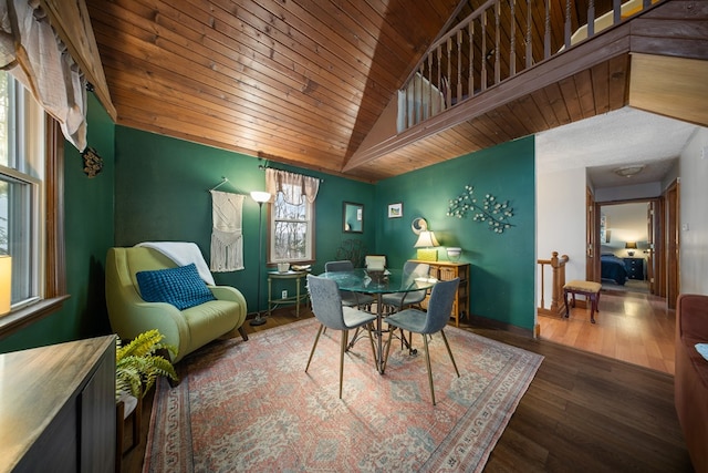 dining area with dark wood-type flooring and vaulted ceiling