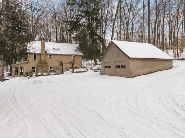 yard layered in snow with a garage