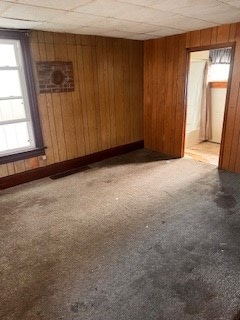 67 S Gamble St, Shelby, OH 44875 - spare room featuring light colored carpet and wood walls