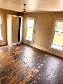 67 S Gamble St, Shelby, OH 44875 - spare room with hardwood / wood-style floors, healthy amount of natural light, and wooden walls
