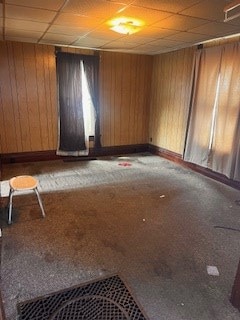 67 S Gamble St, Shelby, OH 44875 - carpeted spare room featuring a paneled ceiling and wood walls