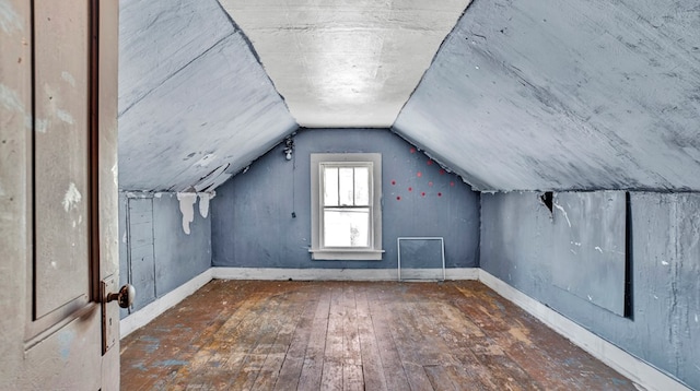 bonus room featuring lofted ceiling and dark hardwood / wood-style floors