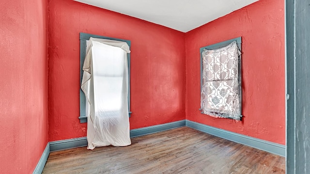 spare room featuring hardwood / wood-style floors and a wealth of natural light