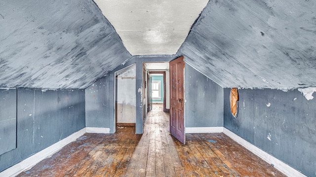 bonus room featuring dark hardwood / wood-style flooring and vaulted ceiling