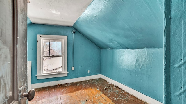 additional living space featuring lofted ceiling and wood-type flooring