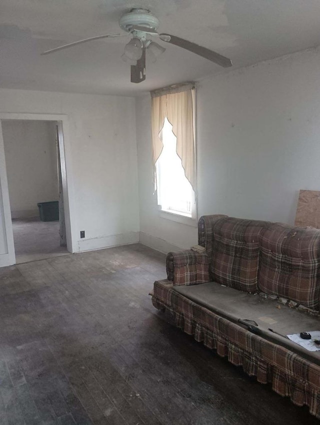 living room featuring wood-type flooring and ceiling fan