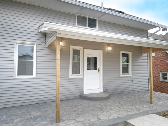 view of exterior entry with a porch
