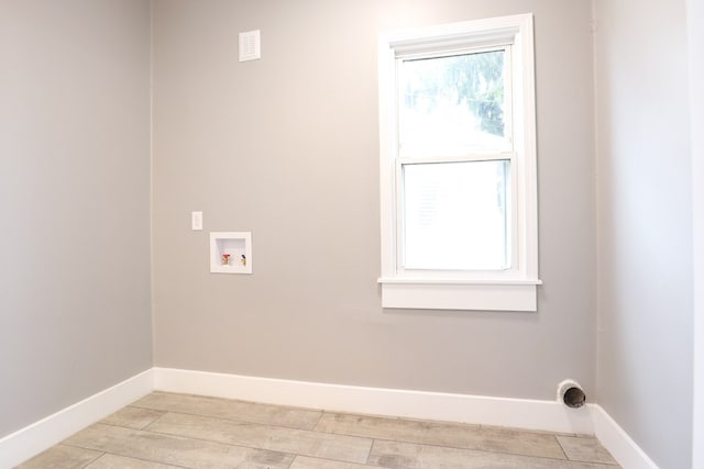 washroom with baseboards, laundry area, and hookup for a washing machine
