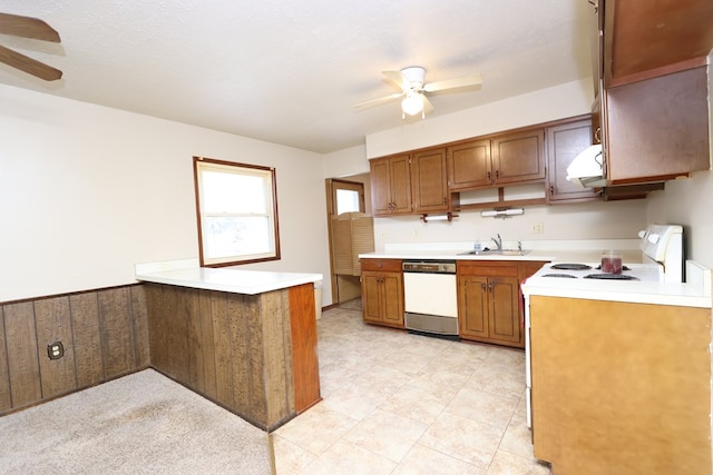 kitchen featuring sink, dishwasher, kitchen peninsula, range with electric cooktop, and ceiling fan