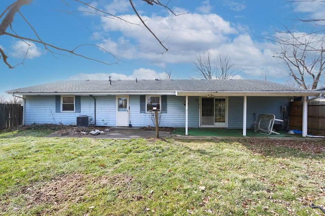 rear view of house featuring a yard and central AC