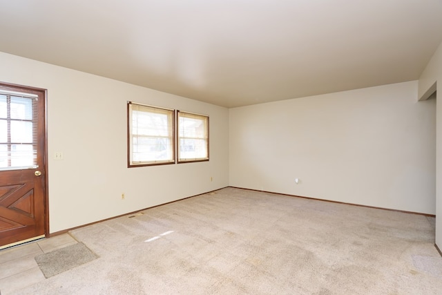 carpeted spare room featuring a healthy amount of sunlight