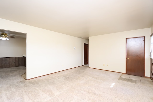 spare room featuring ceiling fan and light colored carpet