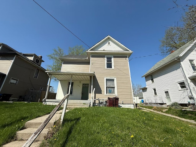 view of front facade featuring covered porch and a front yard