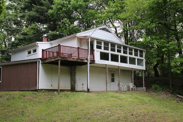 1192 Burger Ave, Mansfield, OH 44906 - rear view of property with a wooden deck, a lawn, view of wooded area, and a sunroom