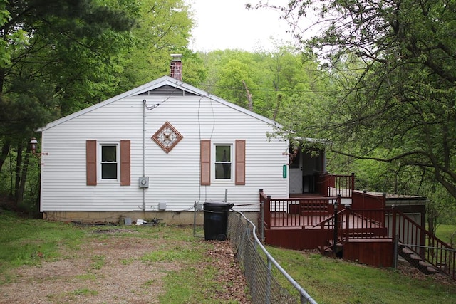 1192 Burger Ave, Mansfield, OH 44906 - rear view of house with a wooden deck, a chimney, a wooded view, fence, and stairway
