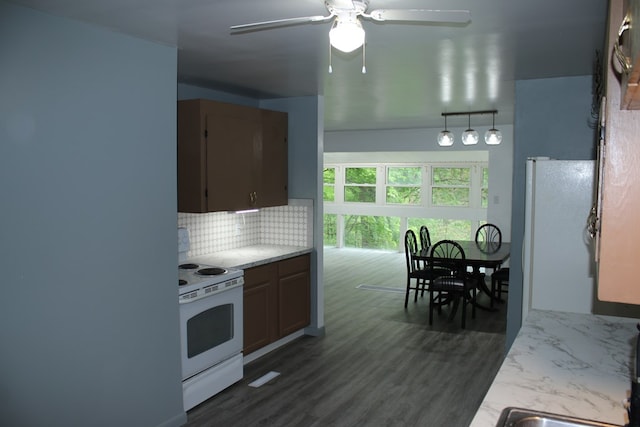 1192 Burger Ave, Mansfield, OH 44906 - kitchen with white appliances, decorative backsplash, a ceiling fan, light countertops, and dark wood-style floors
