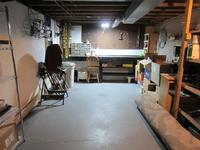 unfinished basement featuring a workshop area