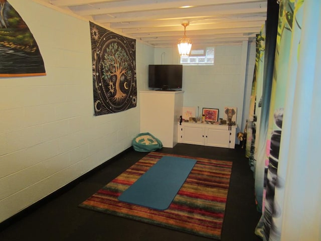 rec room featuring concrete block wall