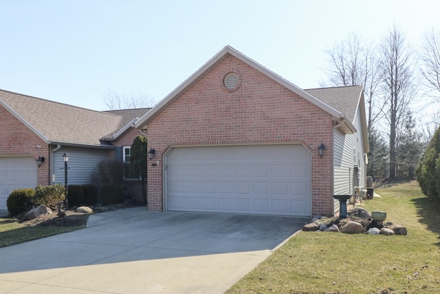 ranch-style house with brick siding, an attached garage, concrete driveway, and a front yard