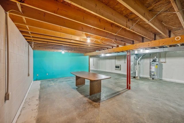 unfinished basement featuring heating unit and water heater