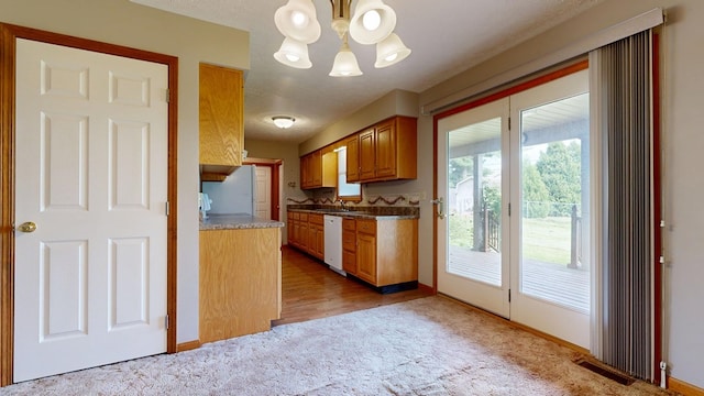 62 Elmridge Rd, Mansfield, OH 44907 - kitchen featuring light colored carpet, a chandelier, white appliances, and baseboards