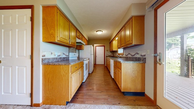 62 Elmridge Rd, Mansfield, OH 44907 - kitchen featuring white appliances, a sink, under cabinet range hood, light wood-style flooring, and dark countertops