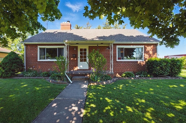 40 Hopewell Ave, Tiffin, OH 44883 - view of front facade featuring brick siding, a chimney, a front yard, and roof with shingles
