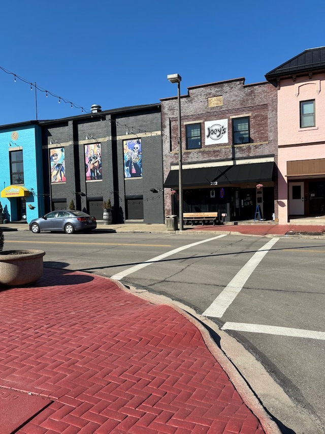 view of road with curbs, street lighting, and sidewalks