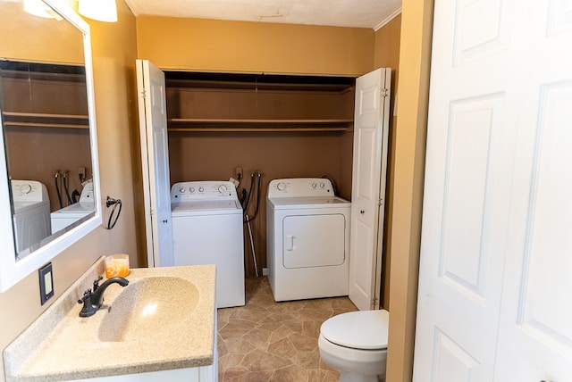 bathroom featuring sink, a textured ceiling, and independent washer and dryer