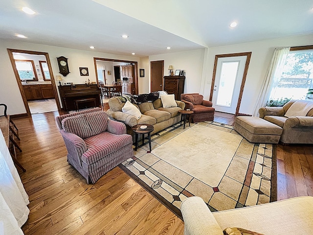living area featuring light wood finished floors, baseboards, and recessed lighting
