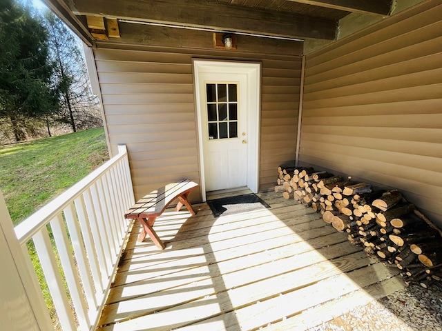 view of exterior entry with a balcony