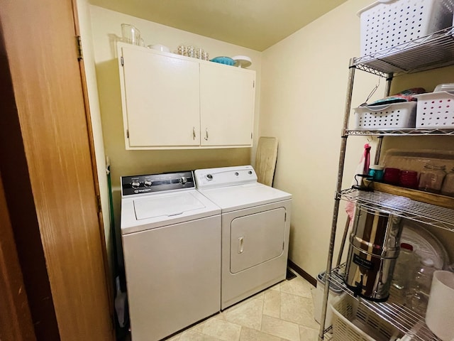 washroom featuring washer and dryer and cabinet space