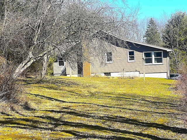 view of side of property featuring a yard