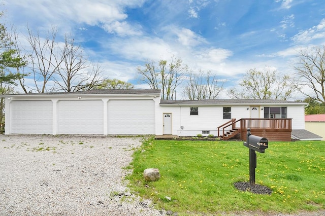 single story home featuring a deck, a front yard, and a garage