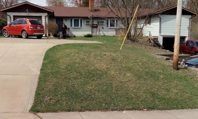 ranch-style house featuring a front yard and a garage