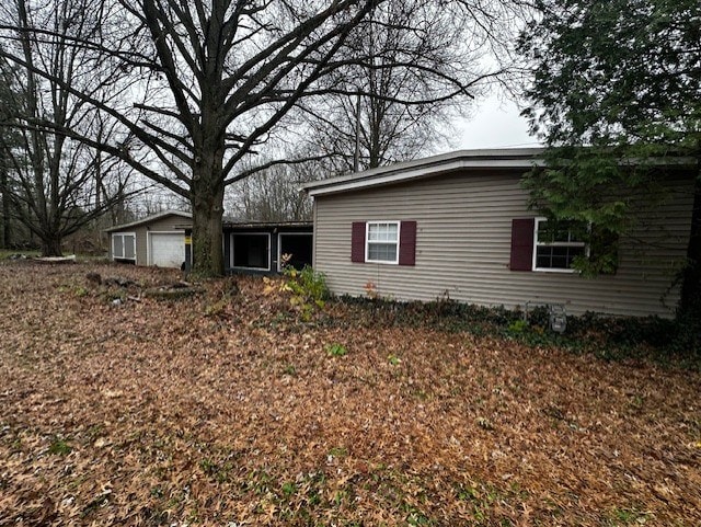 exterior space with an outbuilding and a garage