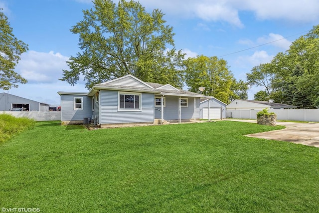 rear view of house featuring a yard and a garage