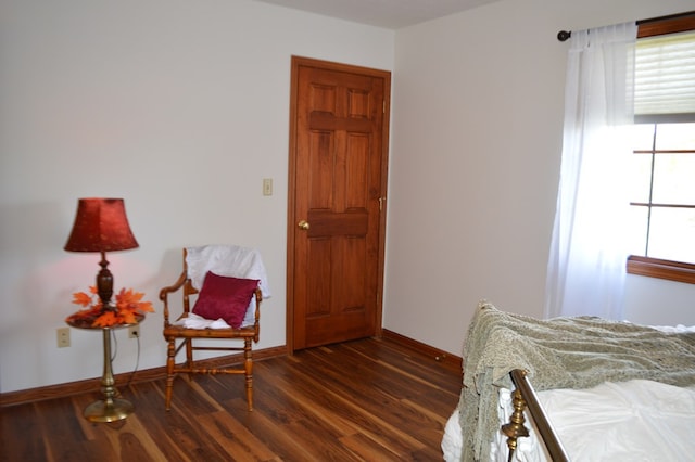 bedroom with dark hardwood / wood-style floors